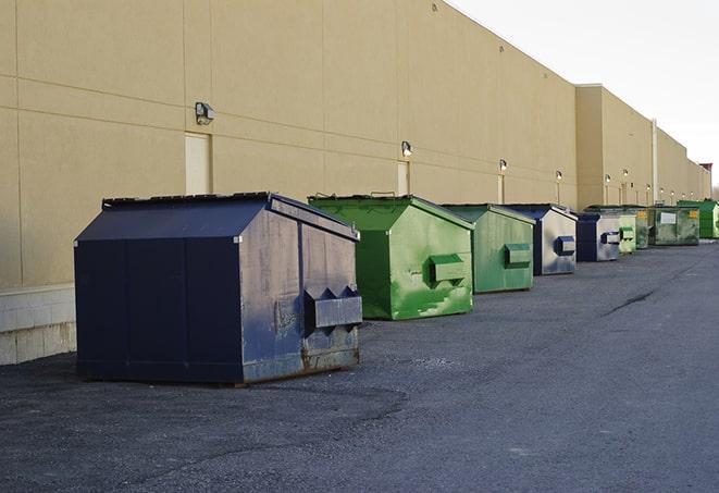 a fleet of red and blue construction dumpsters available for use in Harbor City